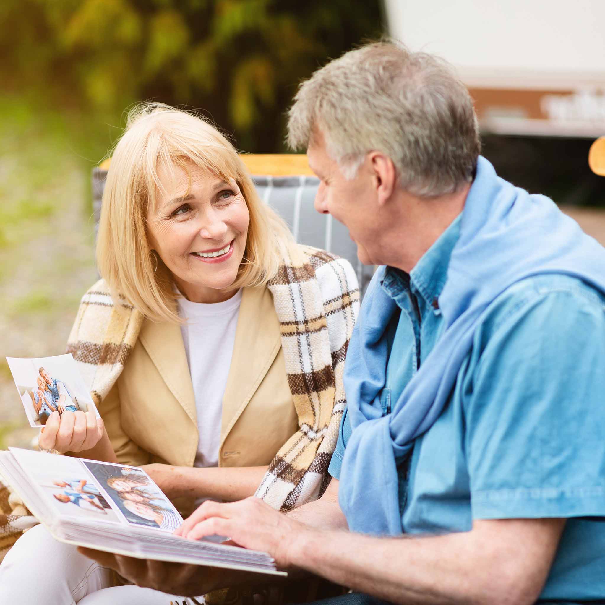 mature couple looking at photos in family album